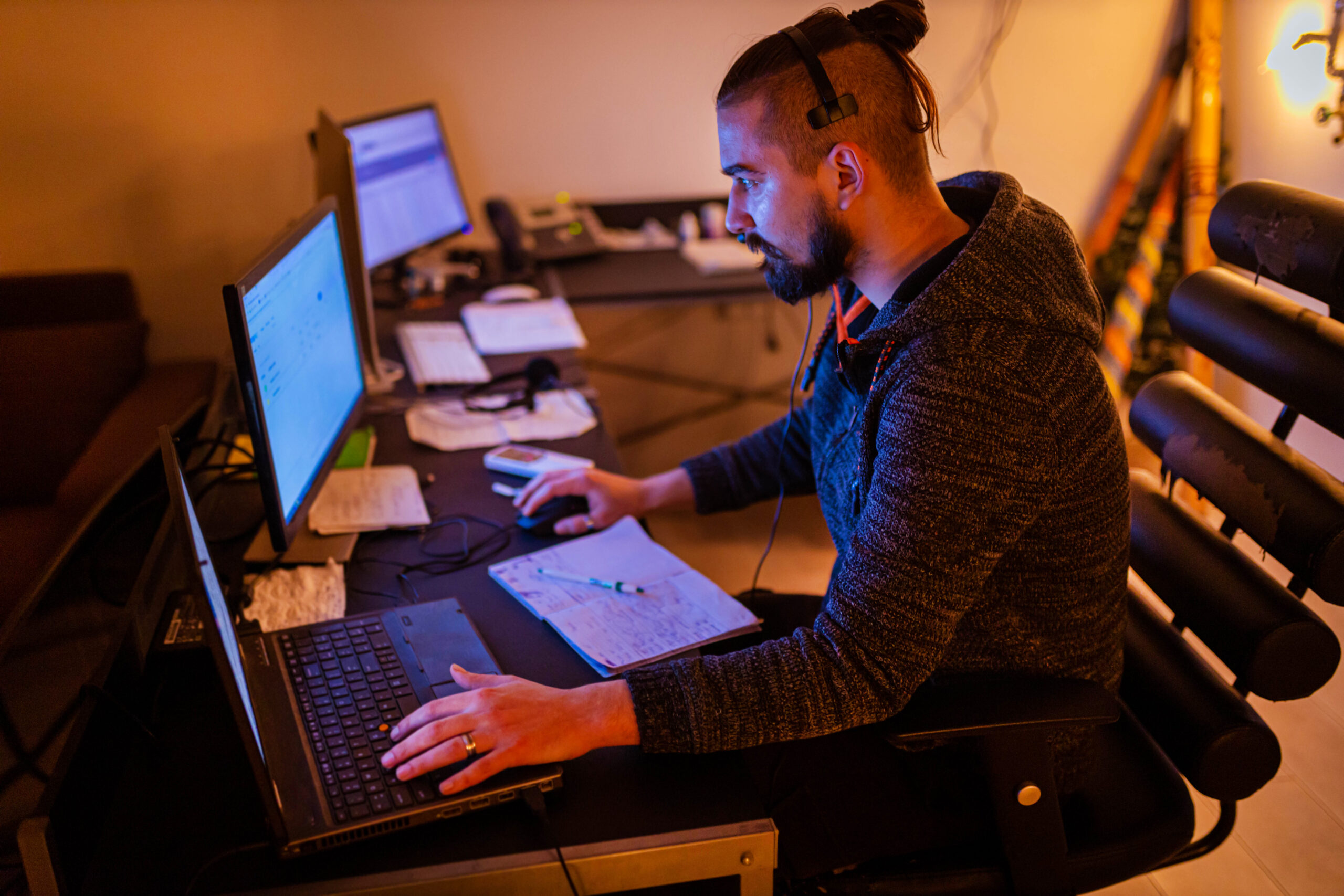 Late at night Caucasian trader working on computer
